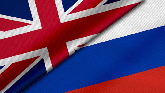 3D Rendering of two flags from United Kingdom or Britain and Russian Federation together with fabric texture.