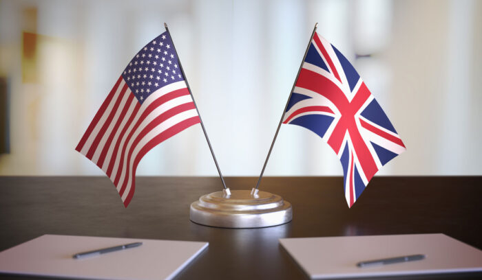 USA and British flags on table.