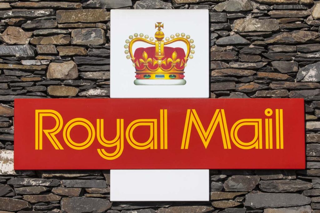 The symbol for Royal Mail on a dry stone wall in Cumbria, UK.
