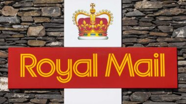 The symbol for Royal Mail on a dry stone wall in Cumbria, UK.