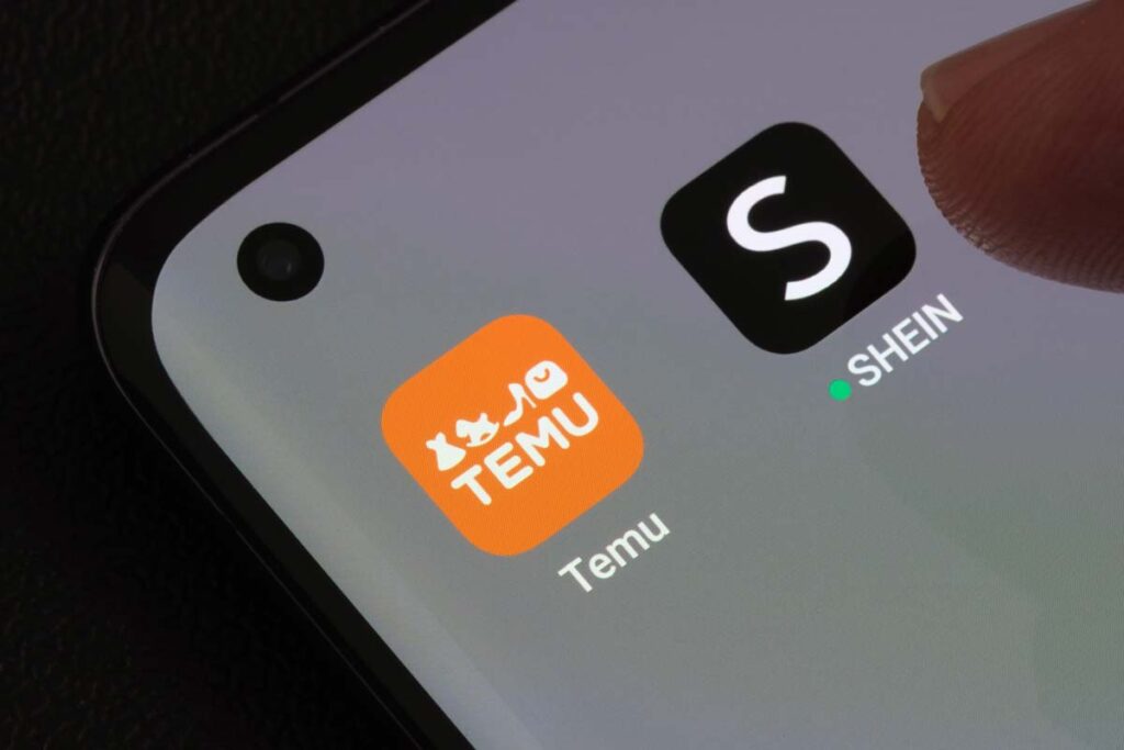 Close up of Temu and Shein app icons displayed on a smartphone screen, representing the Temu lawsuit.