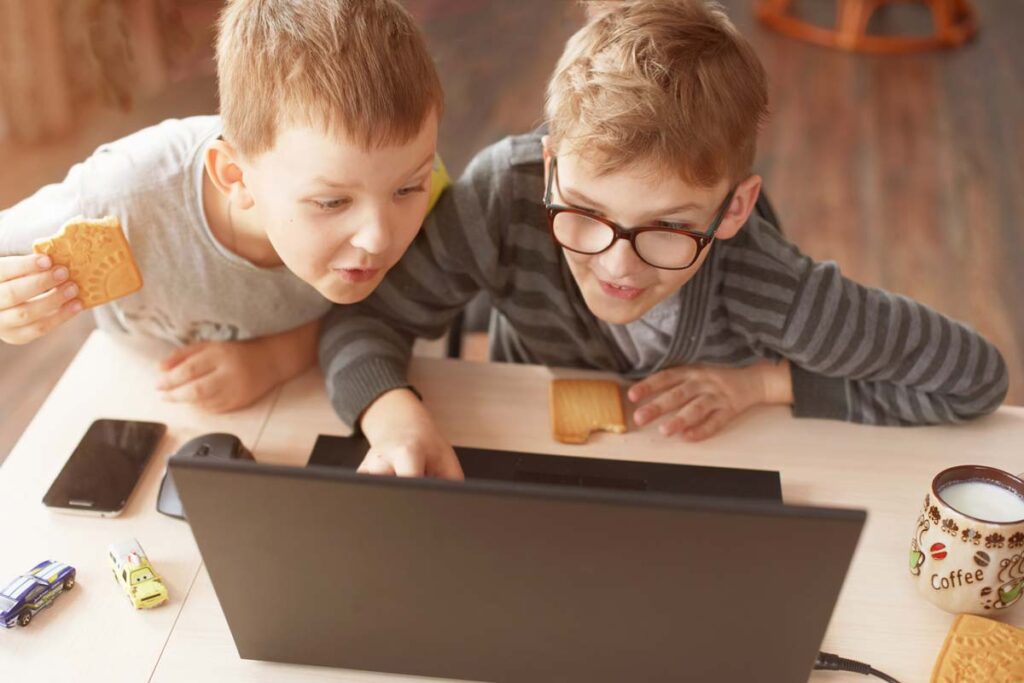 Two young boys using a laptop, representing the Online Safety Act.
