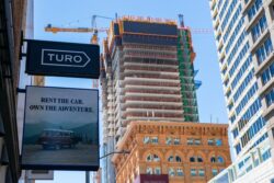 Turo sign on headquarters of online car sharing and peer-to-peer carsharing company