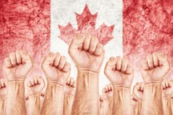 Canada Labor movement, workers union strike concept with male fists raised in the air fighting for their rights