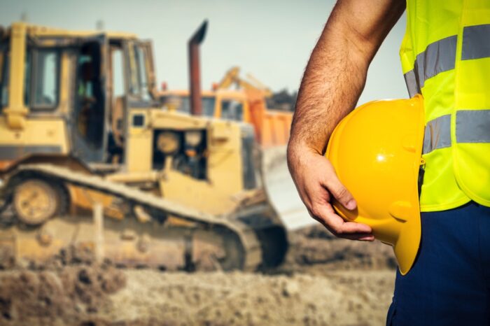 Construction worker in front of winnipeg building site
