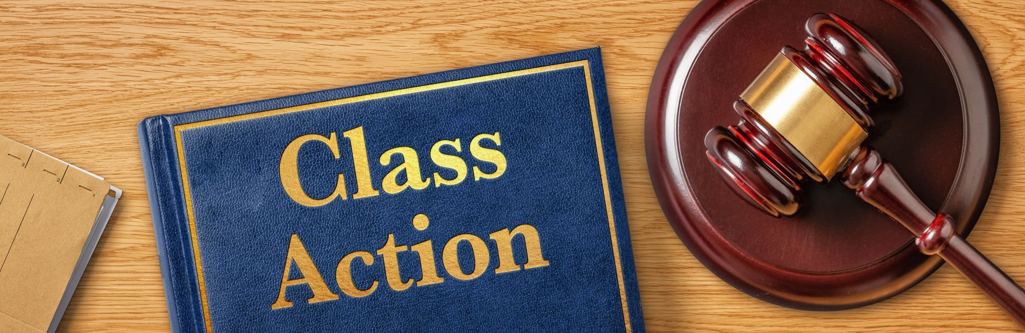 A class action book and gavel regarding what you should know when filing a class action lawsuit.