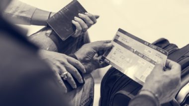Pair of hands holding flight tickets regarding the class action filed against Air Canada over retirement benefits