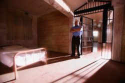 prison guard in an empty cell regarding the federal inmate class action lawsuit filed after a female inmate contracts COVID-19