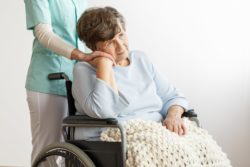 Senior woman upset in wheelchair regarding the care homes class action lawsuit filed against Responsive Group over its handling of COVID-19