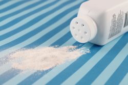 Spilled baby powder regarding Johnson and Johnson discontinuing its talc-based baby powder in Canada 