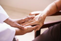 urse hands touching senior persons hands regarding the long-term care homes class action lawsuit filed against a group that operates over 2 dozen facilities
