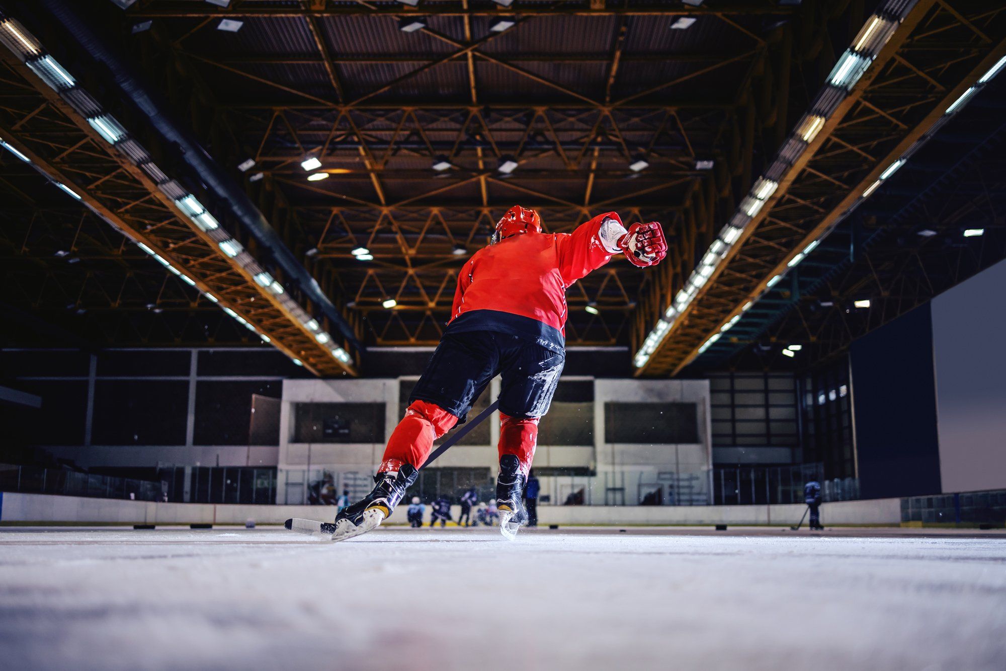 Hockey player skating regarding the Canadian Hockey League minimum wage class action lawsuit settlements 