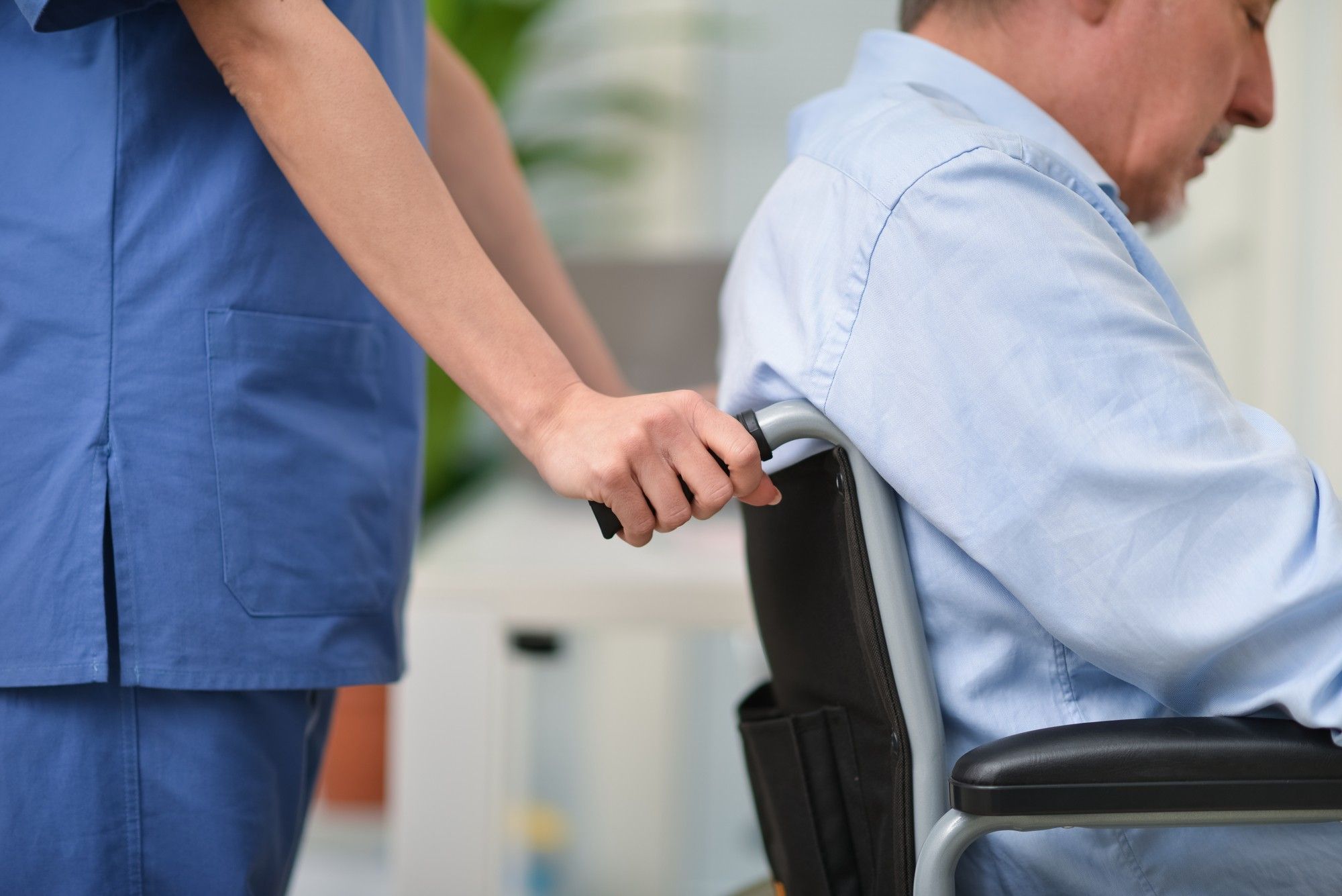 Nurse pushing senior man in wheelchair regarding the nursing home neglect lawsuit filed against Southbridge Care Homes