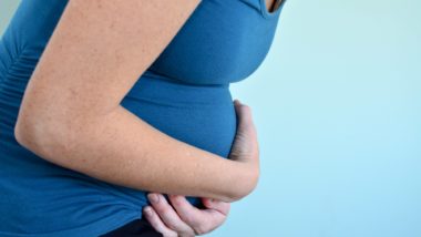 Pregnant woman holding belly regarding the compensation settlement approved for those negatively impacted by morning sickness drug thalidomide