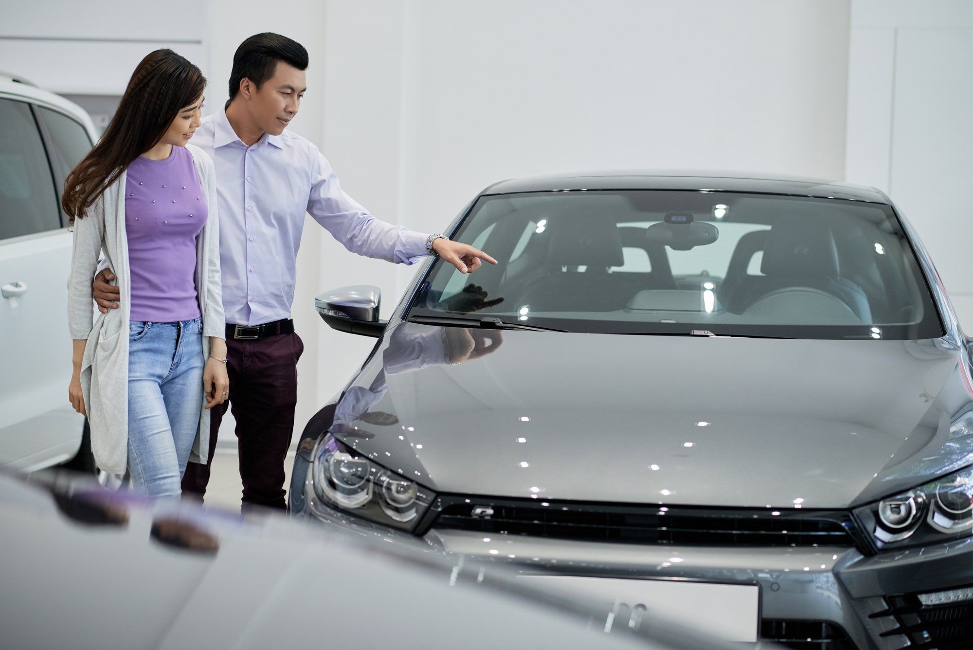 Buyers checking out a car before purchase