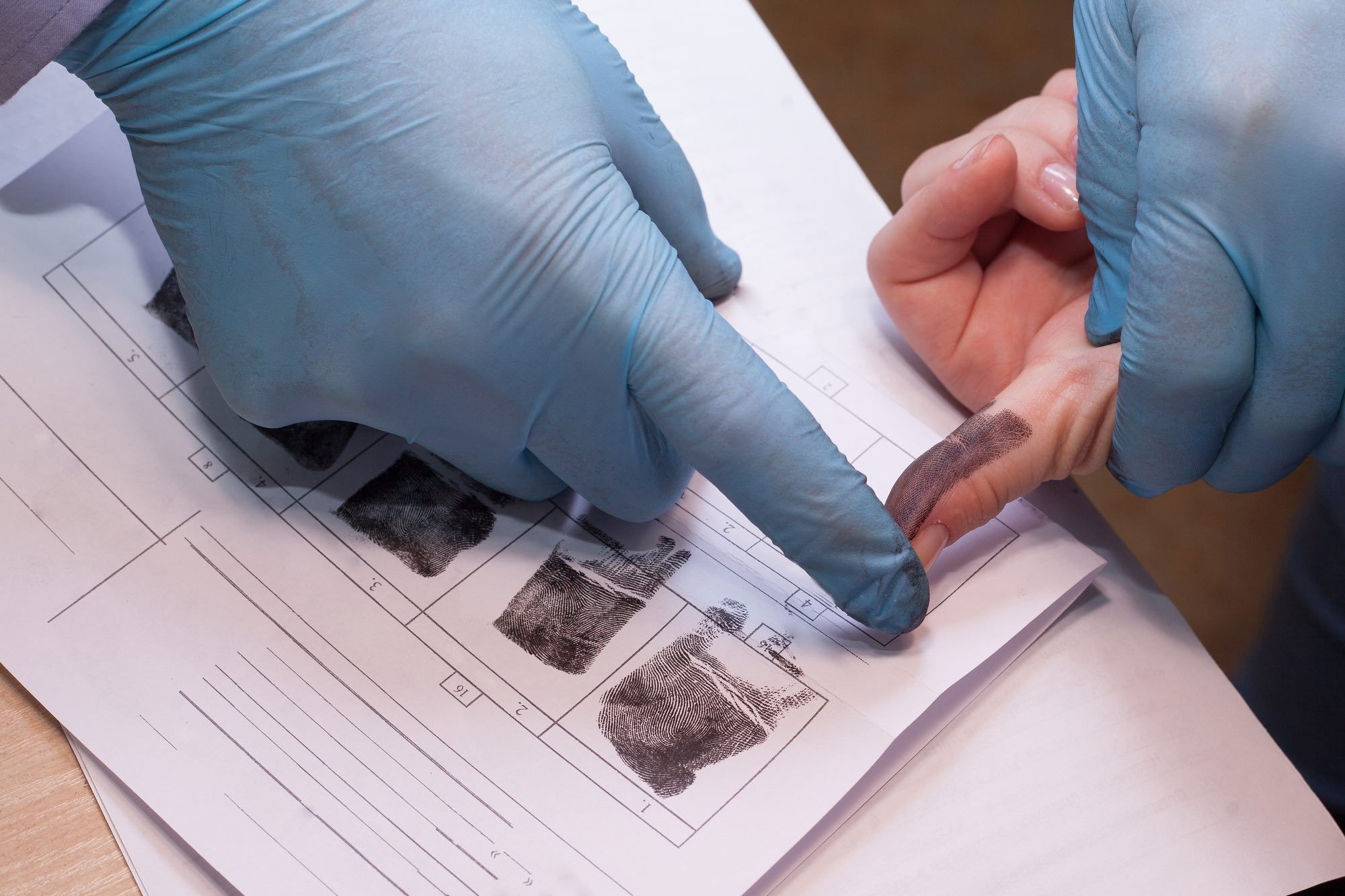 Criminal being fingerprinted for criminal record