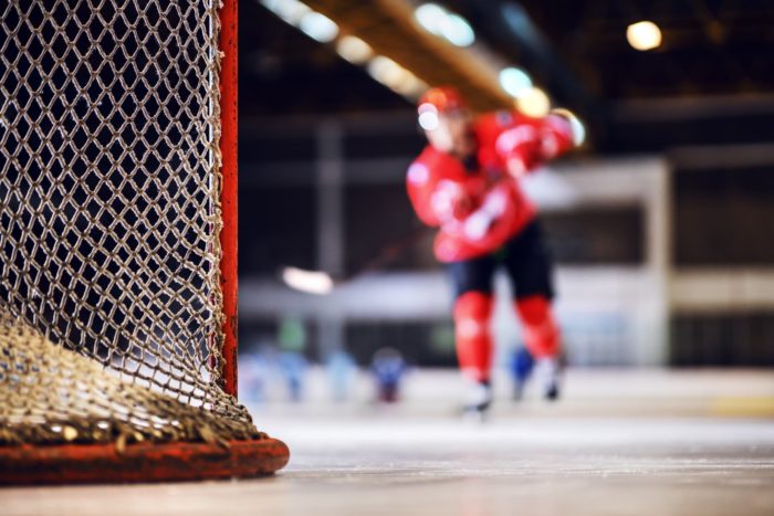 A blurred shot of a hockey player on the ice regarding the CHL abuse and hazing class action lawsuit filed