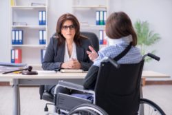 Woman in wheelchair speaking to lawyer regarding information on long term disability lawyers 
