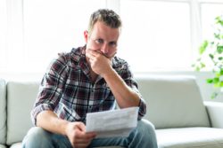 Frustrated man with denial letter regarding information on Sun Life long-term disability insurance denial process 