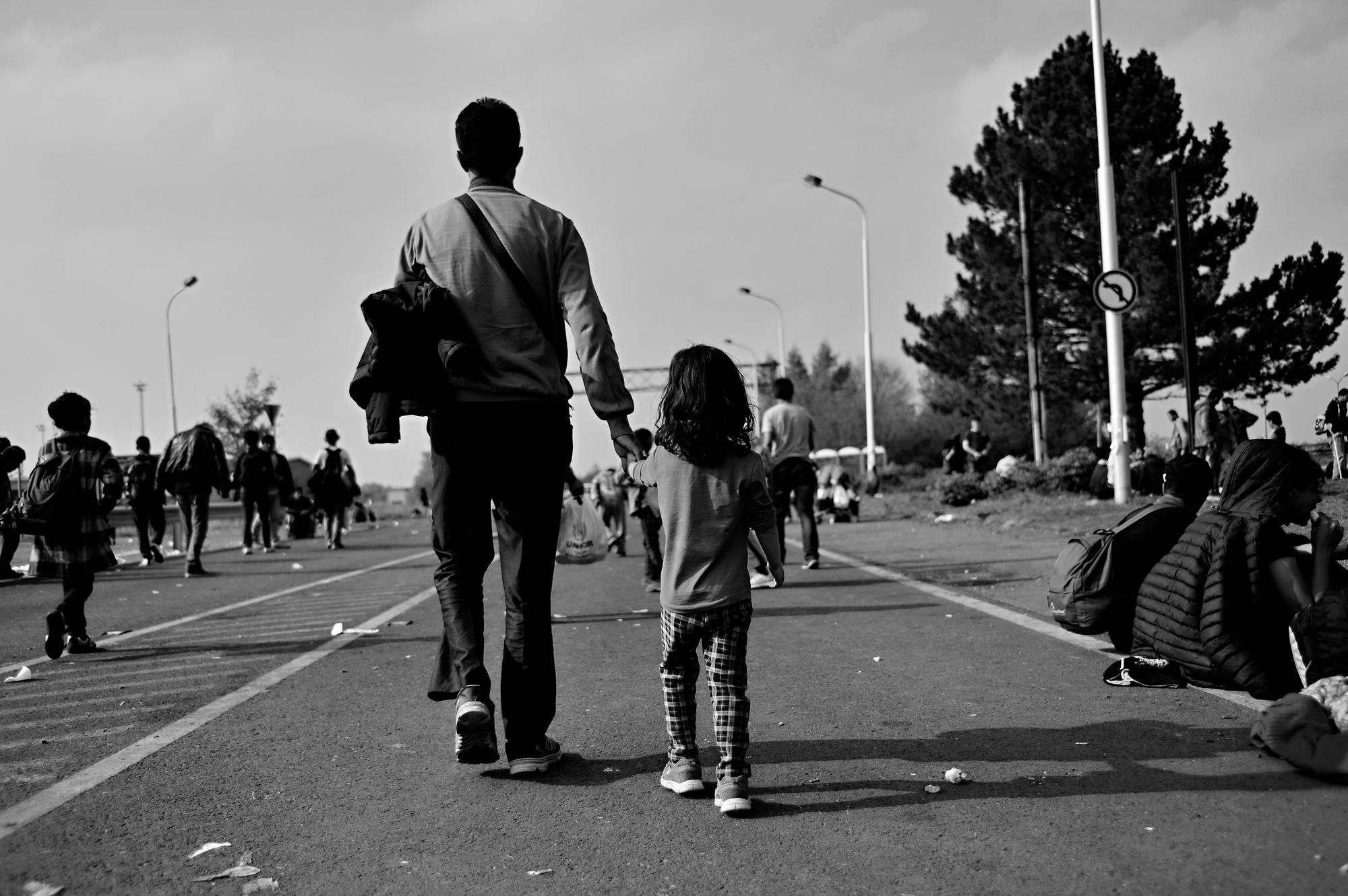 Refugees walking regarding the Roma refugees asylum class action lawsuit settlement 