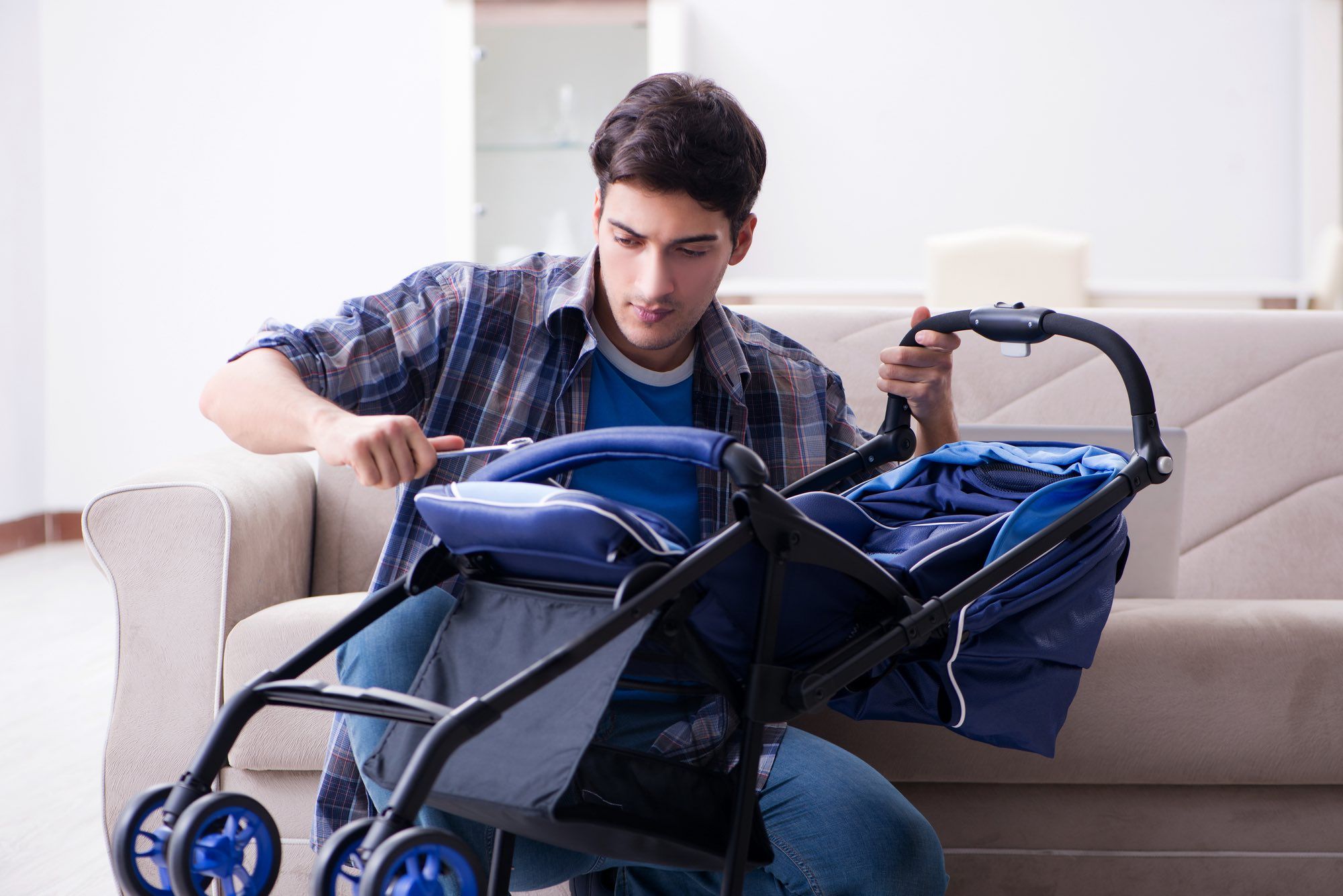 man repairing defective recalled stroller