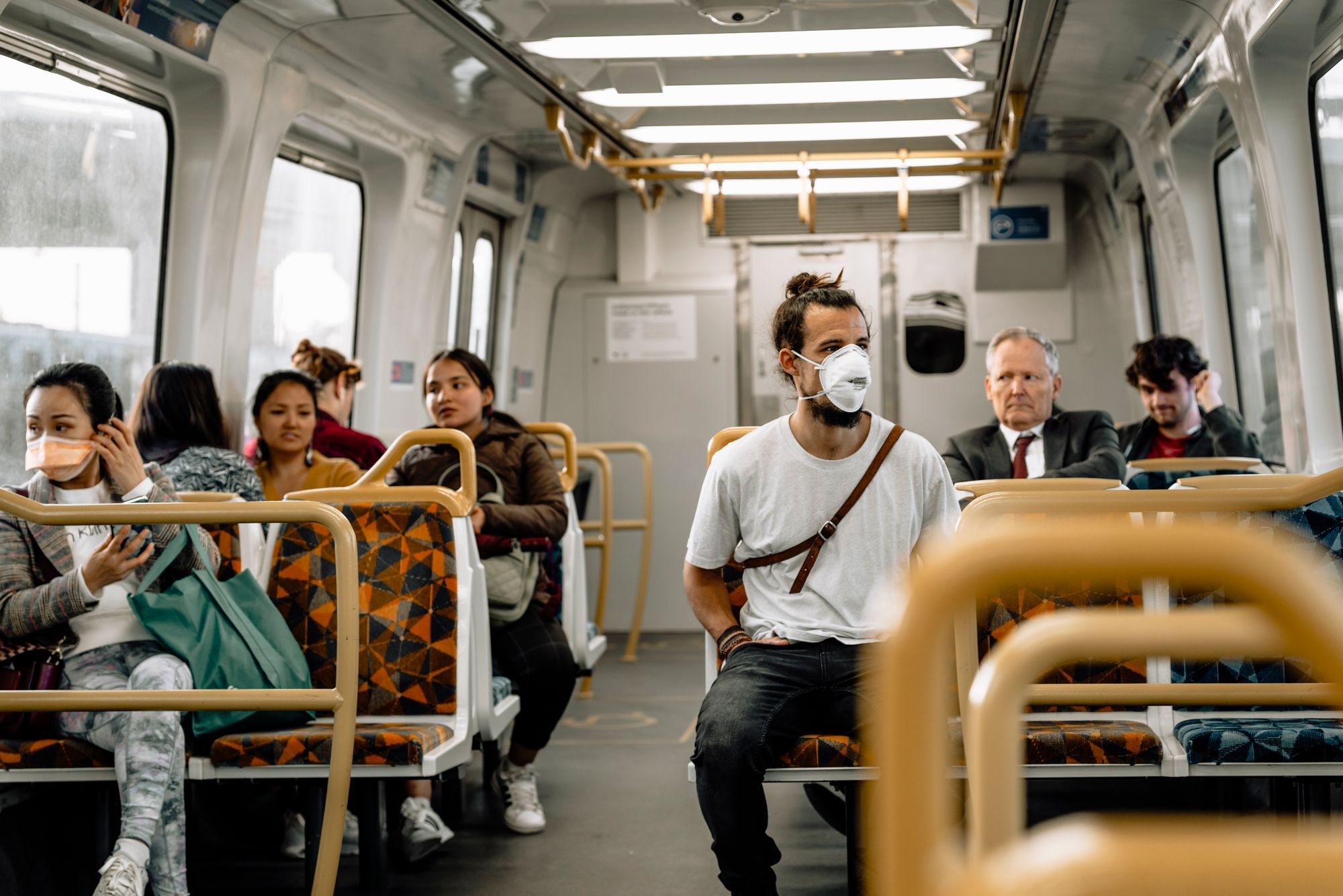 People on a bus, some wearing masks regarding the Vaccine Choice Canada lawsuit filed