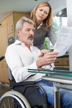Woman looking a letter with man regarding information on what to do if you're terminate on long-term disability