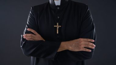 Priest with arms crossed regarding the Catholic Church Appeals to The Supreme Court Over Sex Abuse Lawsuits