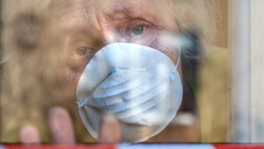 elderly woman in long-term care home wearing mask