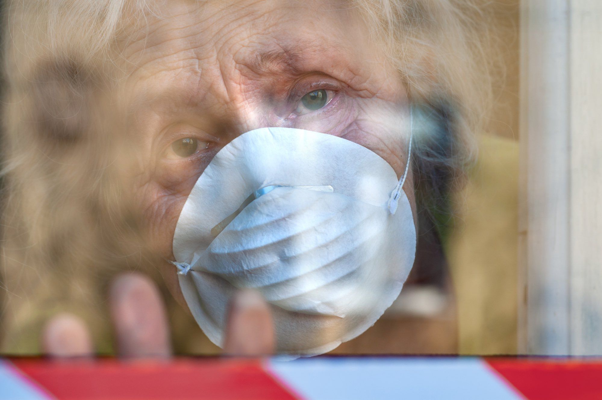 elderly woman in long-term care home wearing mask