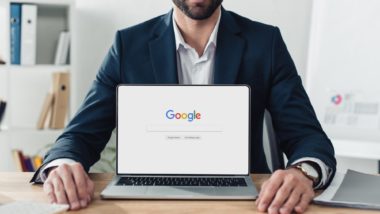 man sitting behind laptop on google page amid class action alleging privacy breaches