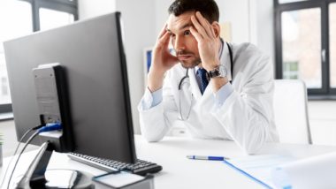 Stressed doctor realizing there's a data breach regarding the CarePartners class action lawsuit