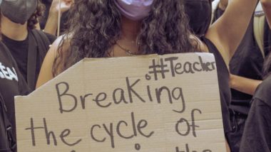 Teacher protesting racism regarding the Scholar Strike Canada