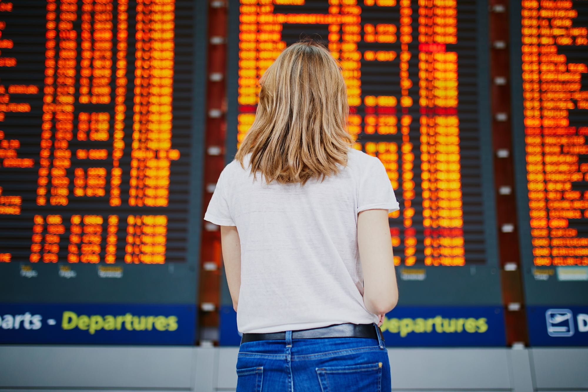 woman looking at cancelled flights for which vouchers were offered instead of refunds