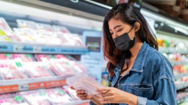 Woman reading food label regarding the consumer products recalled due to allergens