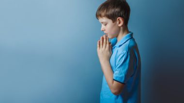 Boy praying during church sexual abuse