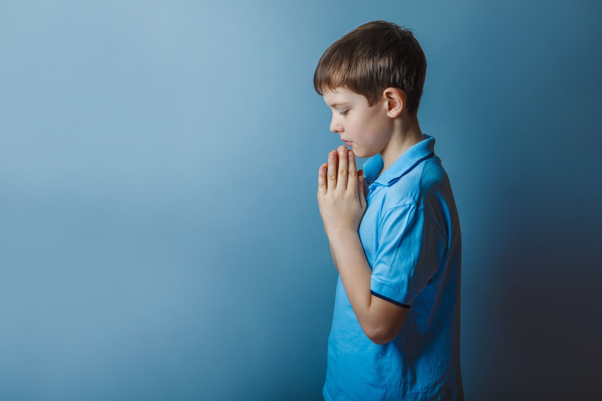 Boy praying during church sexual abuse