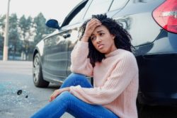 Woman having car trouble regarding the Fiat Chrysler Automobile class action lawsuit filed 
