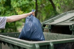 Man dumping trash regarding the environmental and fuel surcharges class action lawsuit 