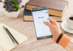 Google on smartphone regarding the Google privacy class action settlement 