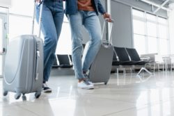 Couple with suitcases regarding baggage fees class action lawsuit 