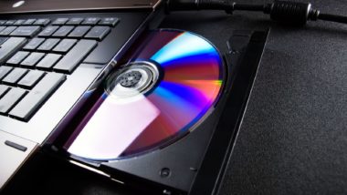 A CD in an optical disc drive on a laptop