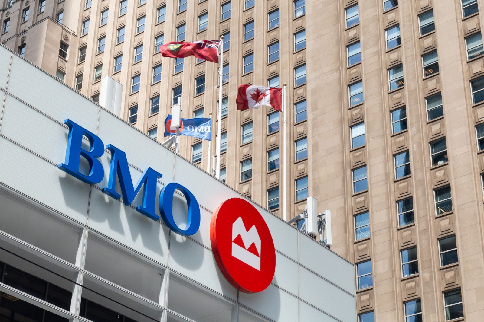Flags fly atop a Bank of Montreal (BMO) building - BMO trust