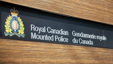 VANCOUVER, CANADA - JANUARY 26, 2015: A sign for the Royal Canadian Mounted Police in English and French along with the crest of the RCMP.