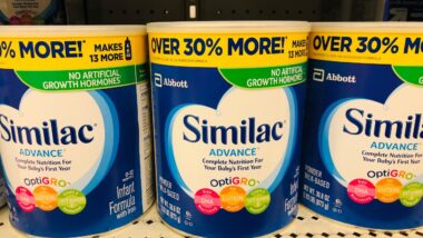 Similac infant baby formula for sale on a shelf inside of a retail store in the baby department.