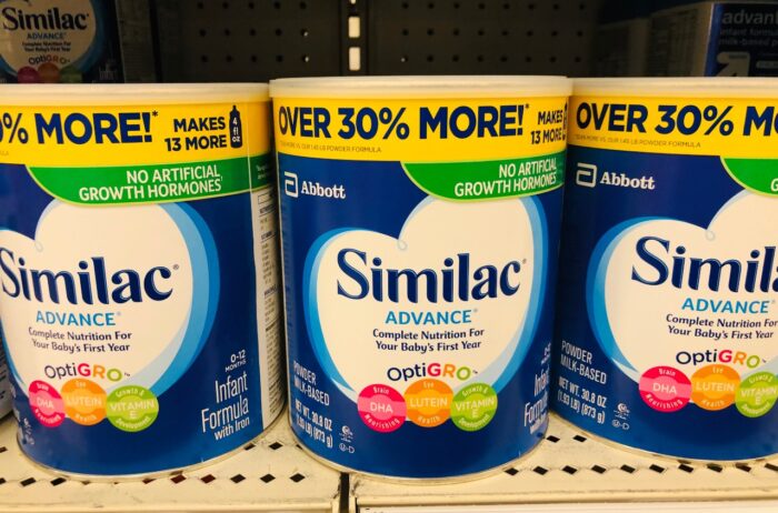 Similac infant baby formula for sale on a shelf inside of a retail store in the baby department.