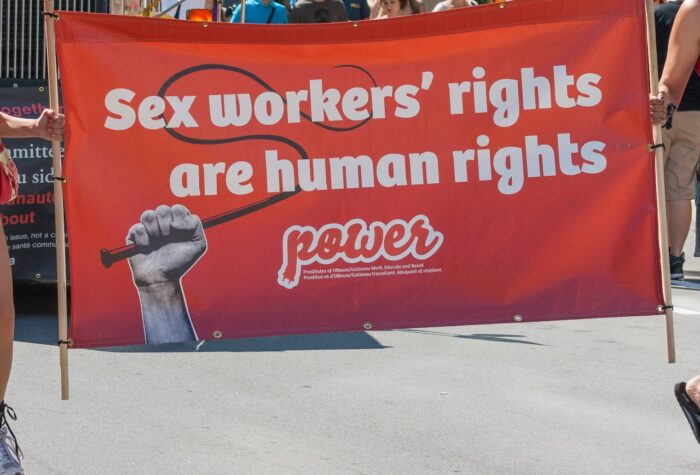Women carrying a banner about sex workers'