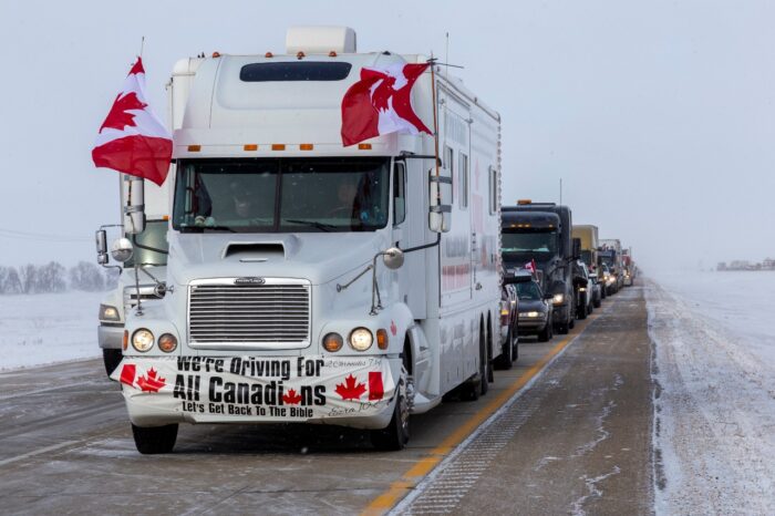 EMERSON, CANADA - JANUARY 29, 2022: Freedom Convoy 2022. Truckers and supporters protest mandatory vaccinations in Canada.