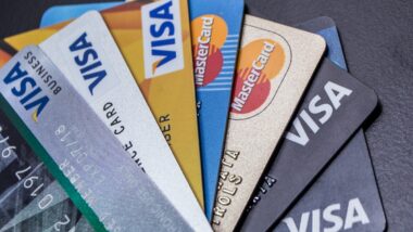 Visa and Mastercard credit cards fanned out against a black background