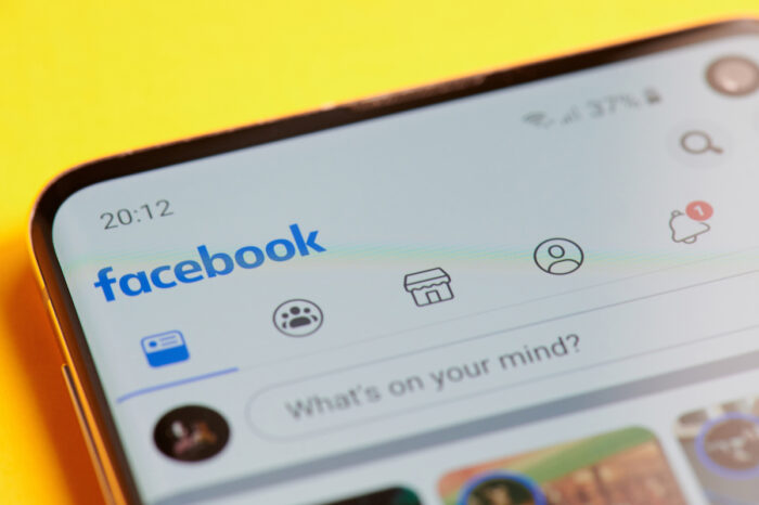 Menu of facebook app in smartphone screen close up view.